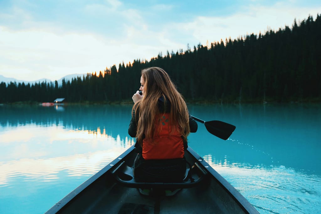 Roberto Nickson Woman In A Canoe On A Lake Unsplash